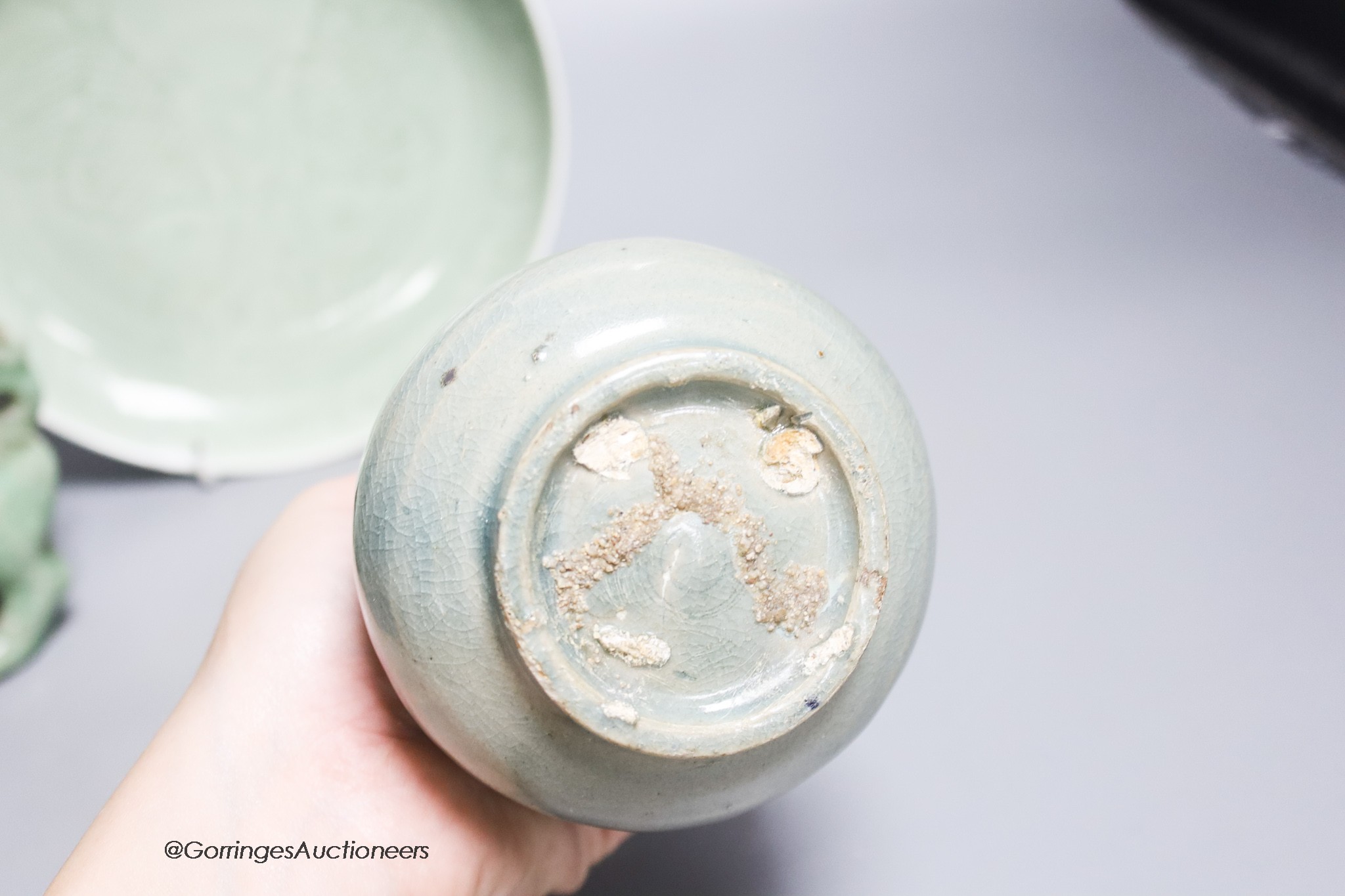 A Korean celadon glazed vase, a Chinese celadon glazed dish together with a similar shi-shi box and cover, largest diameter 20cm